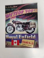 Front view of the Royal Enfield Meteor 700 tin sign with colorful motorcycle advertisement.