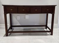 Front view of the rustic wooden console table showing two drawers and metal handles, straight legs and lower frame