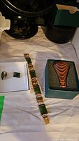 Full view of the lot including bracelet, earrings, pendant and dragonfly scope in box