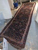 Full length view of runner laid on concrete floor, shows overall dimensions and pattern.