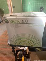 Front and top view of original Xbox 360 Go Pro box showing product branding and some wear on the box.