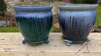 Two planters side by side on deck outdoors showing overall shape and glaze pattern
