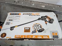 Photo of the product box showing Worx HydroShot 20V power cleaner with 320 PSI specification and branding.