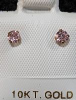 Close-up of front view showing the pink cubic zirconia stones set in 10K yellow gold on a white card labeled 10KT. GOLD