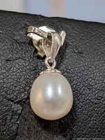 Close-up front view of the silver freshwater pearl pendant showing the pearl and the silver bail.