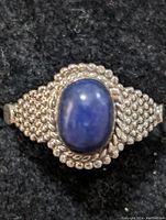 Top view of sterling silver ring showing blue lapis lazuli stone and surrounding beaded silver detail.