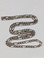 Sterling silver chain laid out to show full length and overall look of the linked chain necklace.