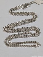 Full view of the sterling silver chain laid out showing length and clasp
