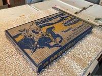 Image showing game box top with Ambush game title and knight illustrations