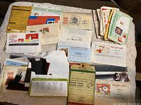 Top view of numerous film negatives strips and envelopes spread out on a white cloth.