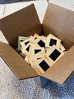 Open box filled with vintage Kodak photo slides in cardboard mounts