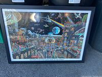 Framed 'Echoes from The Dark Side of the Moon' Pink Floyd poster laid flat showing artwork with cosmic and architectural montage visuals.