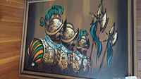 Frontal view of the oil painting showing three Spanish soldiers in ornate armor with greenish-blue plumes on their helmets.