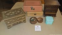 All six jewelry and trinket boxes arranged on a table showing their size and condition