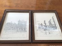 Both framed pencil sketch prints by Wally Exum displayed side by side on a wooden surface, showing general condition including looseness of picture and glass in frames.