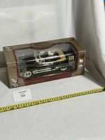 Full view of 1:18 scale Road Legends diecast 1949 Cadillac Coupe DeVille boxed model showing car inside clear display window and box shape and design.