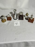 Photo showing all six miniature NHL trophies from 2003 McDonald's set including the Stanley Cup replica.