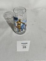 Glass tumbler showing full front view with R2-D2 and C-3PO illustrations and The Empire Strikes Back logo.