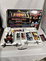 Full set in original box with styrofoam tray, showing all lion vehicles and weapons alongside box artwork