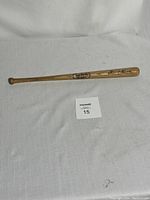 Full view of wooden mini baseball bat with visible signature and brand logo.