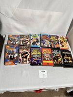 Full lot of 12 wrestling and sports VHS tapes, arranged with cover titles visible