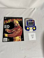 Photo showing WWF Hulk Hogan handheld electronic game and Hulkamania magazine side by side on a white surface