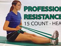 Photo showing a person performing an exercise using the green TheraBand resistance band, highlighting its use for fitness and rehabilitation exercises.