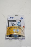 Front view of the A&D Medical LifeSource Ear Thermometer sealed in original retail plastic packaging showing the thermometer with ergonomic design and product features.
