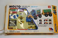 Box front showing colorful plastic truck building set pieces with packaging text and vintage graphics.