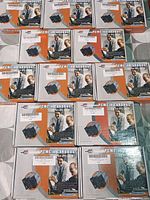 Overview of 12 boxed PCMCIA Cardbus USB adapters arranged on a surface.