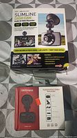 Photo showing SLIMLINE Dash Cam Audio & Video Recorder in factory packaging with details on features