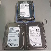 Photo showing three Seagate Barracuda hard drives stacked, two 250GB and one 500GB model visible.