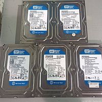 Lot of five Western Digital 250GB internal hard drives arranged in a grid, showing the top labels with model and specifications.
