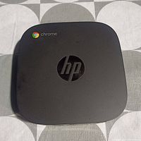 Top view of HP Chromebox G2 unit showing HP logo and Chrome logo.