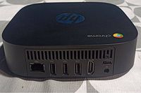 Rear view showing Ethernet port, 3 USB Type-A ports, 1 HDMI port, 1 USB Type-C port, 3.5mm audio jack, ventilation and power input.