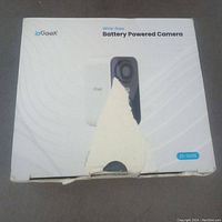 Front of IoGeek camera box with brand, model ZS-GX35, and image of the camera. Box shows some wear and torn section.