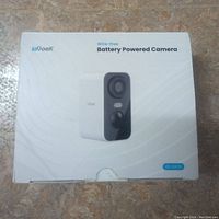 Photo of the front of the ioGeek wire-free battery powered camera box showing the brand, model, and camera image.