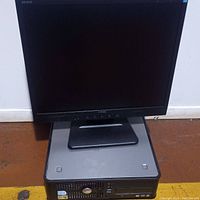 Dell small form factor desktop computer and Dell flat panel monitor on top.