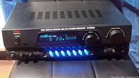 Front view of the Pyle PT280A digital AM/FM stereo receiver showing power button, digital display with blue illuminated control buttons, mic volume and master volume knobs.