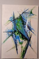 Full view of the original abstract painting on canvas showing the entire 40x60 inch piece with a white background and abstract blue, green, and black angular shapes with splatter effects