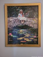 Full view of framed painting showing girl sitting on stone wall with lily pads below.