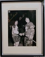 Framed black and white NHL photo showing Richard and Stanley shaking hands with their gold signatures visible.