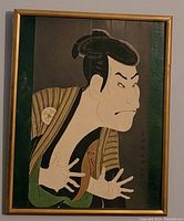 Framed full view of the antique Ukiyo-e Japanese woodblock print depicting Kabuki actor Otani Oniji III in the role of Edobei with stylistic stripes on kimono and hand gesture