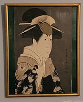 Full framed woodblock print in gold frame showing a female figure in traditional dress.