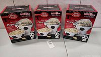 Front view of three boxed Betty Crocker Game Time Soccer Hot Air Popcorn Makers arranged side by side showing product images and branding.