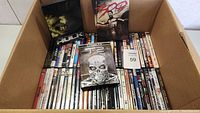 Box of 62 DVDs including Hulk, 300, Terminator 2 and others.
