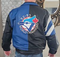 Back view showing half blue, half black leather with large embroidered '92-93 World Champions' logo