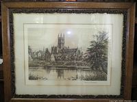 Framed etching artwork of Gloucester Cathedral with wooden carved frame, showing overall view and condition including some sun damage discoloration.