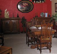 Overall room view showing dining table, chairs, and two matching buffets against wall
