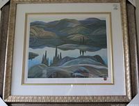 Framed print showing a stylized landscape with mountains and reflections in water in shades of purple, blue, green, and brown.